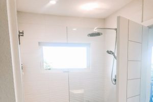 modern white bathroom with glass shower wall