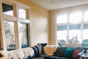 clean living room with lots of blankets and rustic hardwood floors