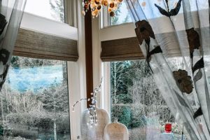 clean master soaker tub with wrap around windows and a view of the trees