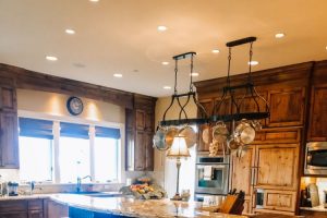 large warm farm style kitchen with dark browns and lots of lights