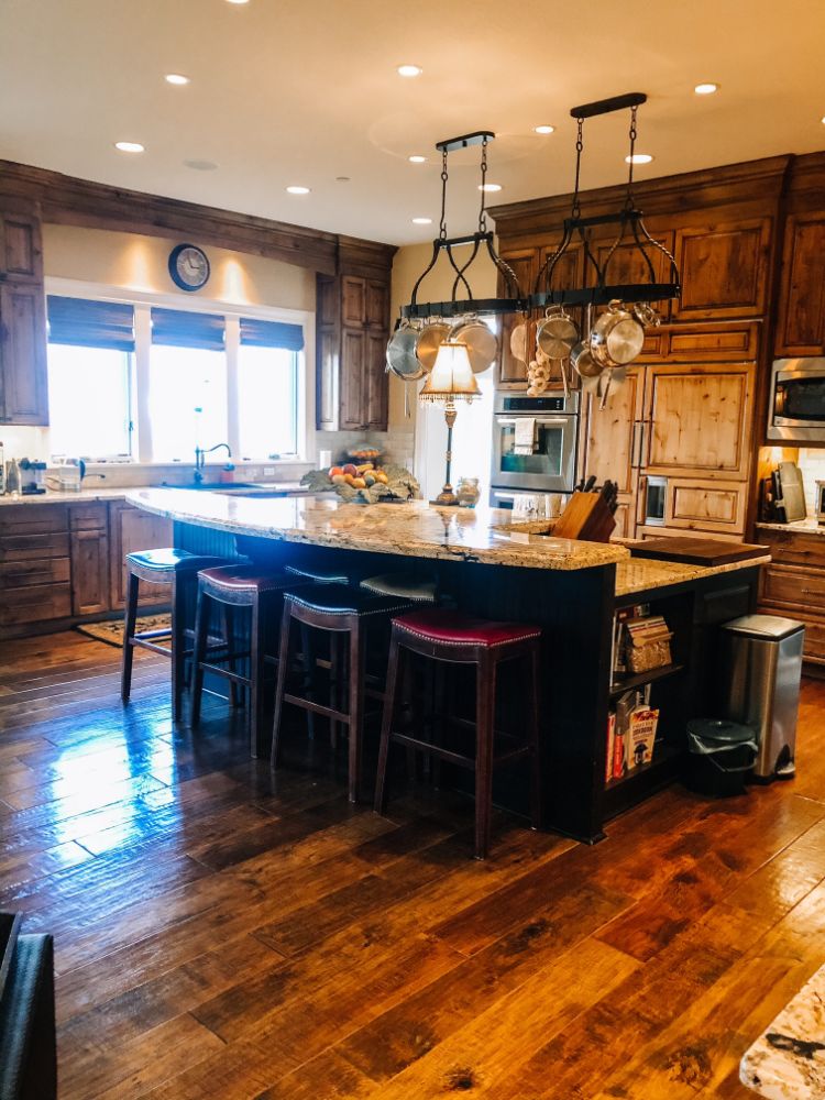 large warm farm style kitchen with dark browns and lots of lights