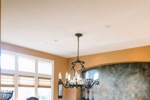 long dining room table with 10 leather chairs and dark rustic hardwood floors