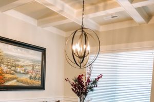 large modern chandelier over dark wood dining set