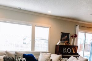 modern living room lots of pillow and upright piano