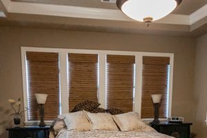 master bedroom with bamboo shades and zebra bench