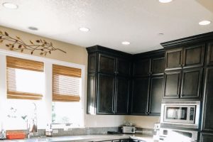 clean kitchen with black cabinets and granite countertops